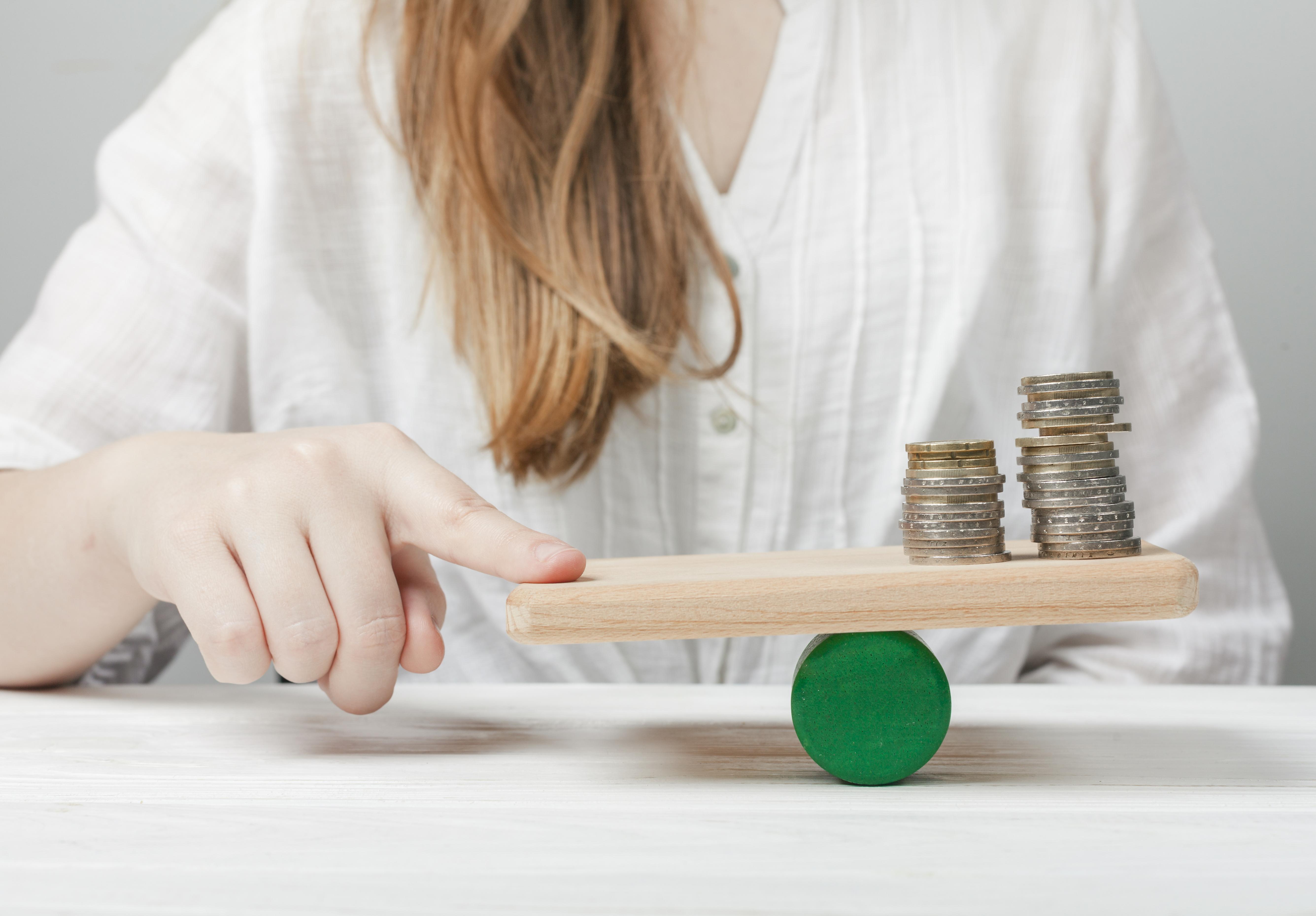 woman-holding-her-finger-balance-with-coins1.jpg